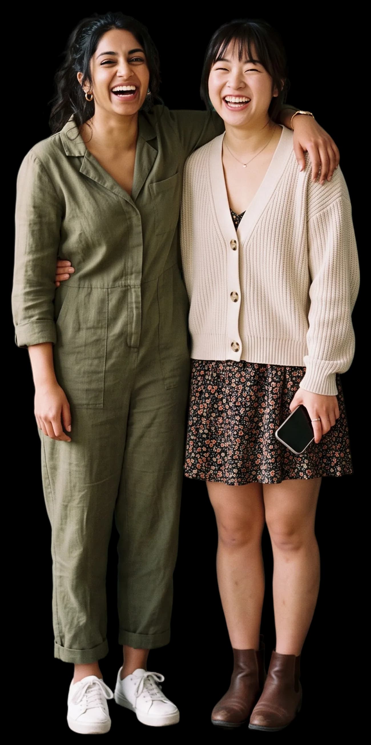 Two friends with arms around each other laughing at the camera