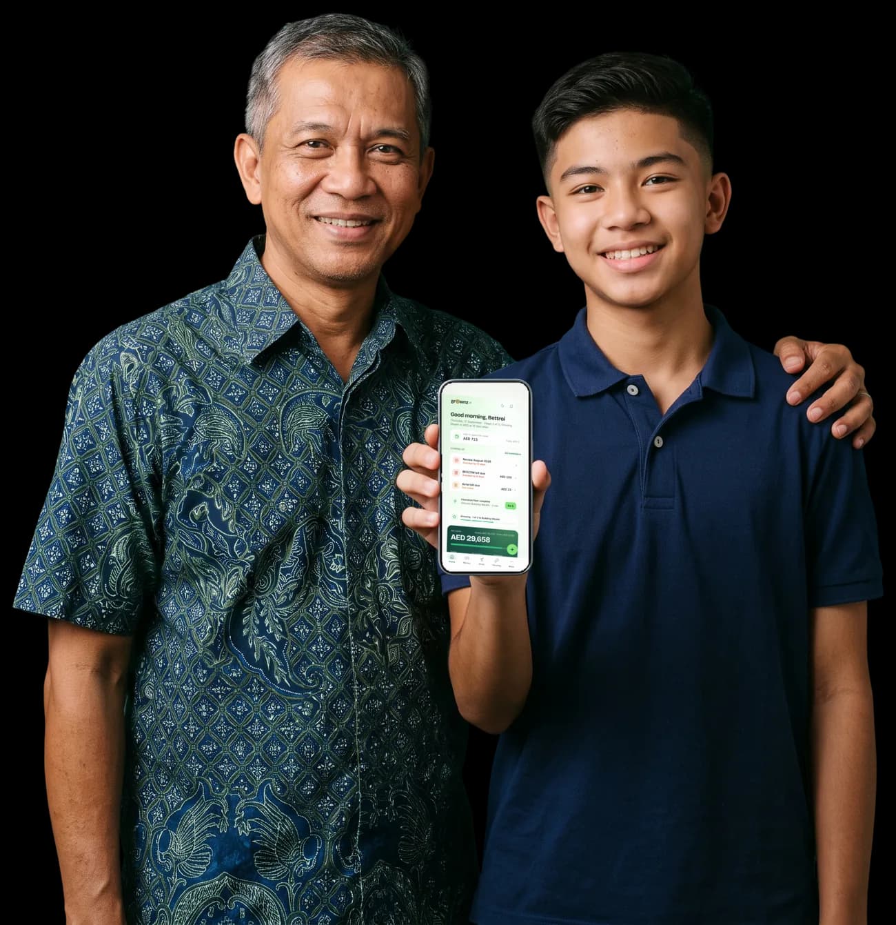 A father and his teenage son, the son holding a phone up to the camera with the Grownz home screen showing