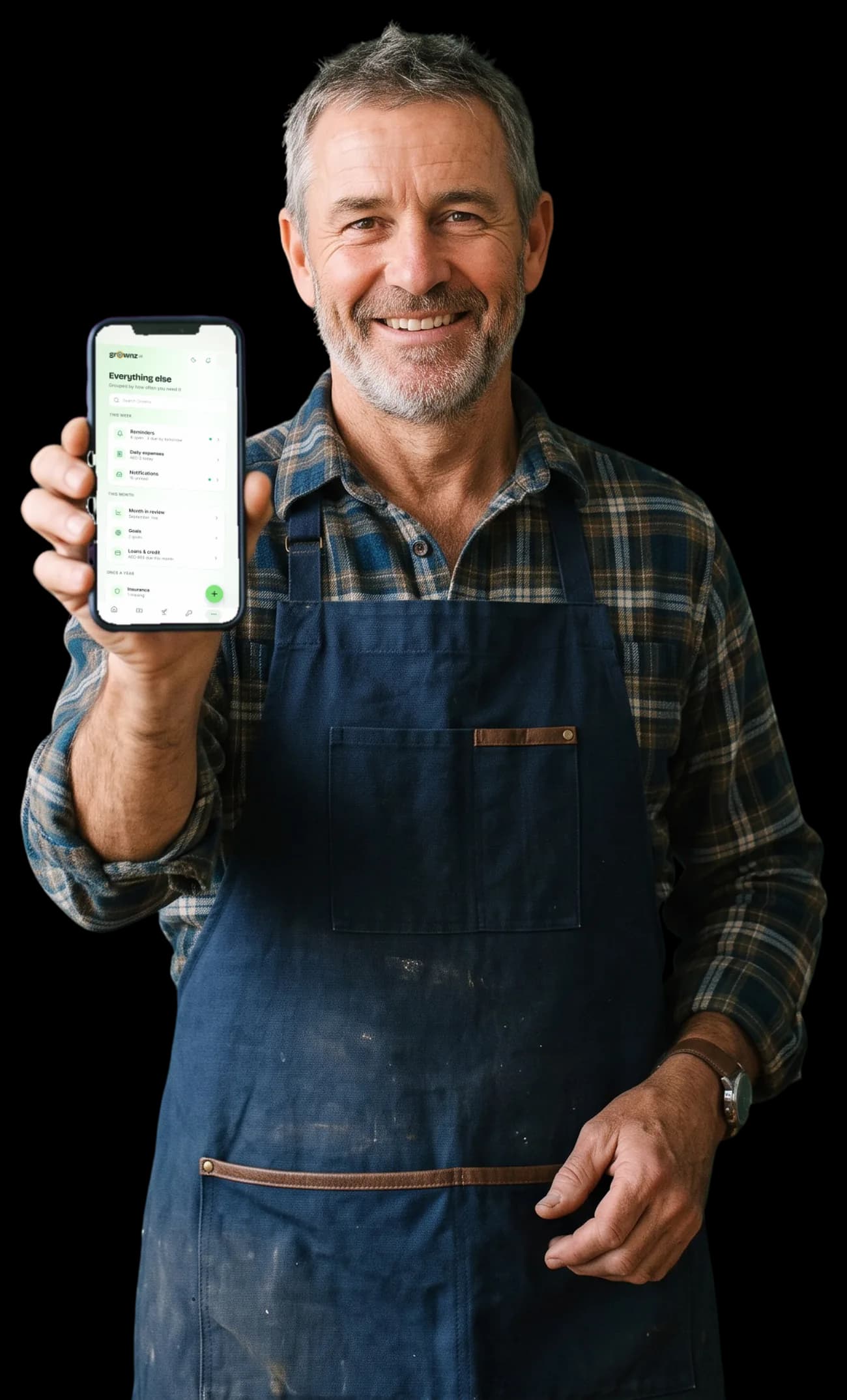 A man in a workshop apron holding his phone up to the camera, the More screen showing