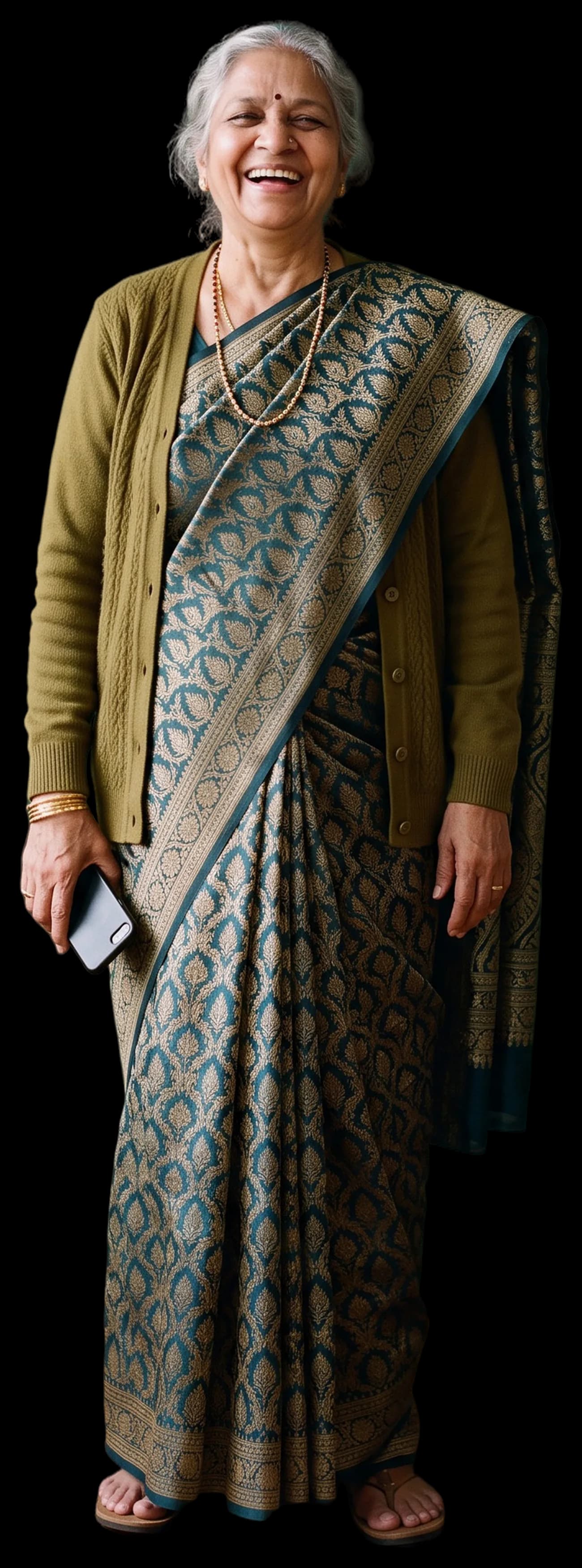 A grandmother in a sari laughing at the camera, phone in hand