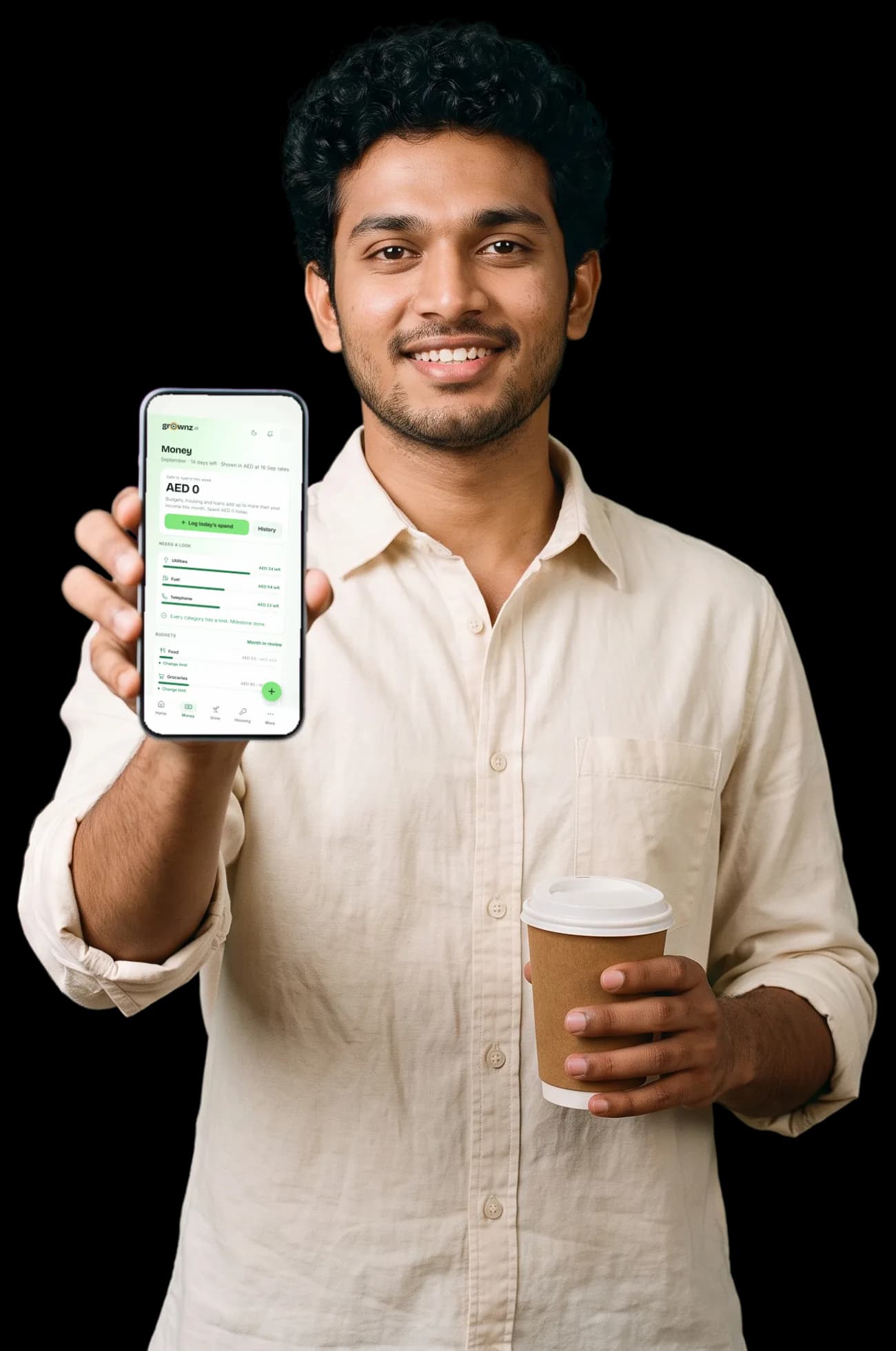 A young man with a takeaway coffee holding his phone up to the camera, the Money screen showing